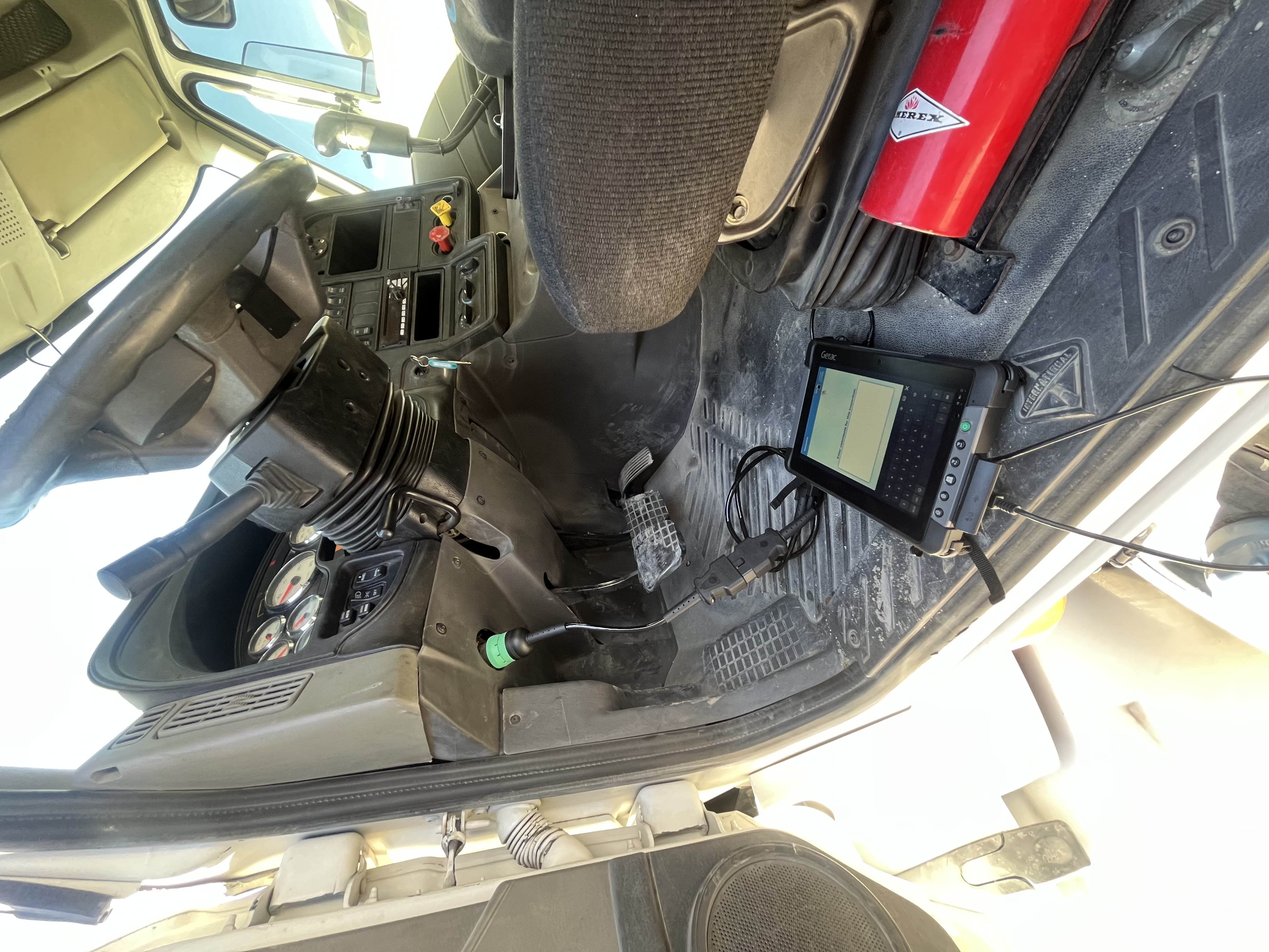 Diagnostic tablet plugged into truck OBD port